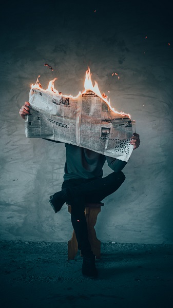 newspaper on fire